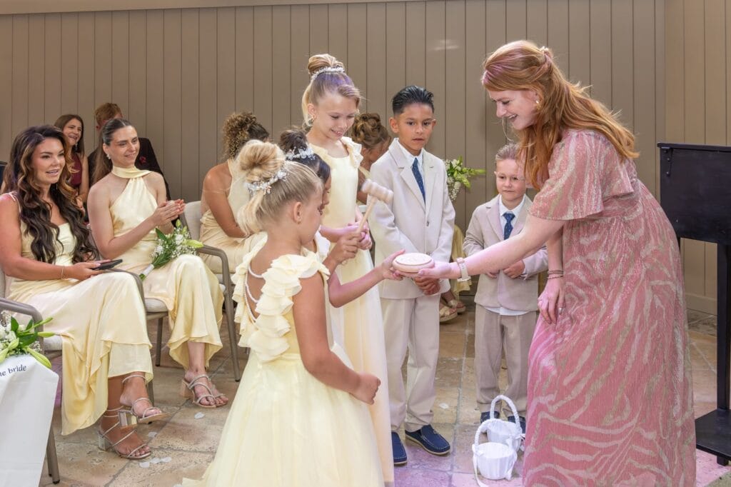 Trouwambtenaar Ingrid van de Coevering laat de kinderen van het bruidspaar het ceremoniële huwelijk bezegelen met een klap met de hamer, op de bruiloft van Joy en Kevin bij 't Kerkje in Schijndel.